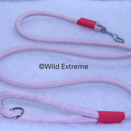 Pink dog leash with red clips on a light blue background, branded 'Wild Extreme'.