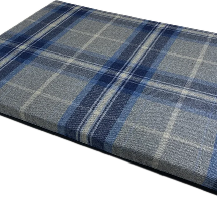 A rectangular plaid cushion or pad in blue, gray, and white tones, shown at an angle on a plain white background.